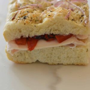 Focaccia bread sandwich with turkey, garlic aioli and roasted red peppers. Quick, easy and oh so delicious!